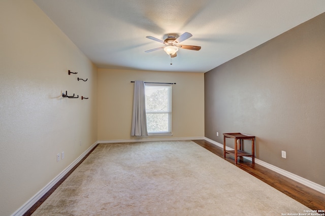 unfurnished room featuring ceiling fan and hardwood / wood-style flooring