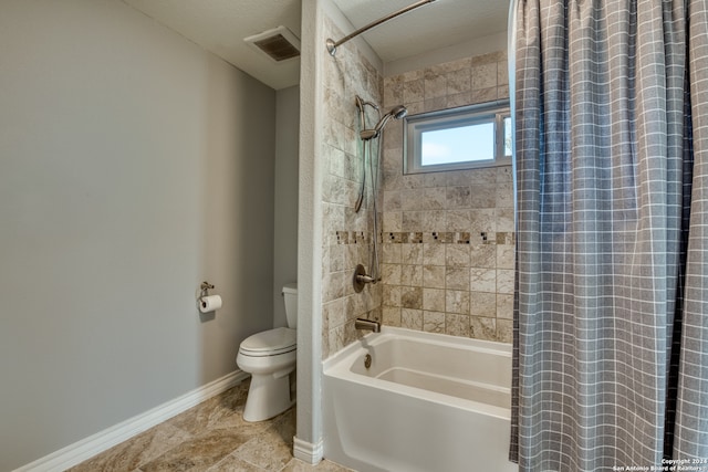 bathroom with a textured ceiling, shower / bath combo with shower curtain, and toilet