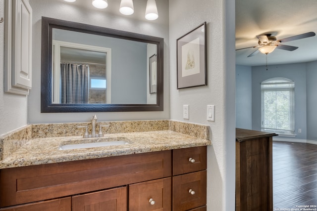 bathroom featuring wood-type flooring, ceiling fan, and vanity