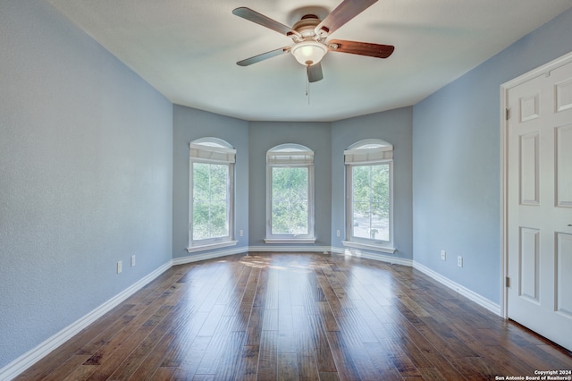 spare room featuring ceiling fan and dark hardwood / wood-style floors