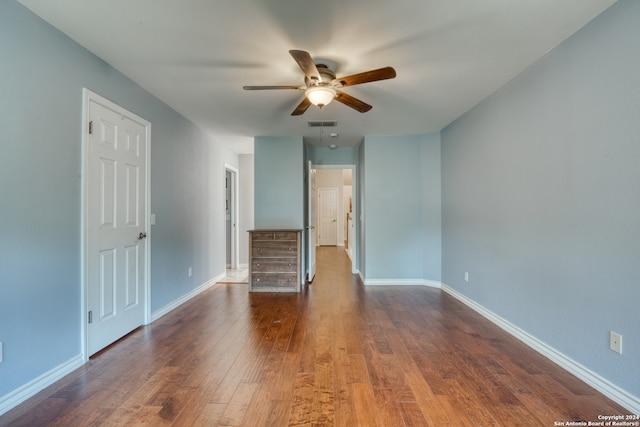 unfurnished room with ceiling fan and dark hardwood / wood-style floors