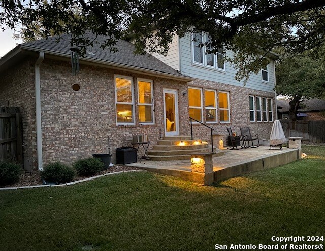 rear view of house featuring a patio and a yard