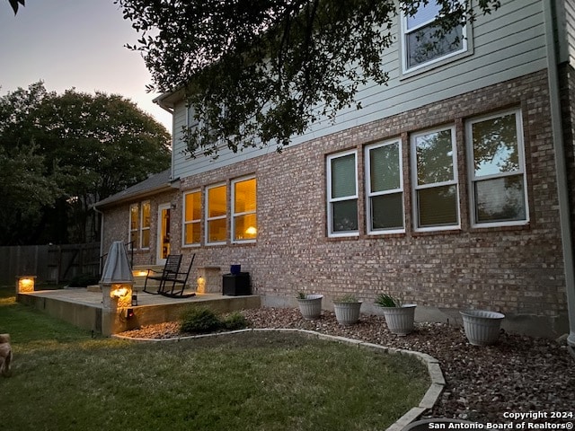 back house at dusk with a yard