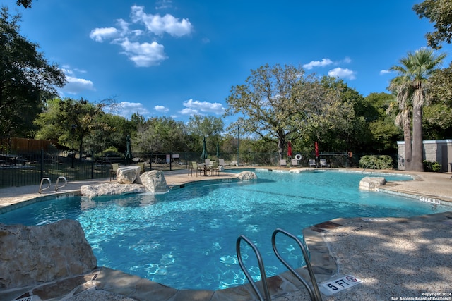 view of pool featuring a patio area and pool water feature