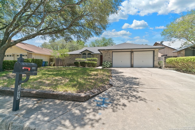 ranch-style home with a front yard and a garage