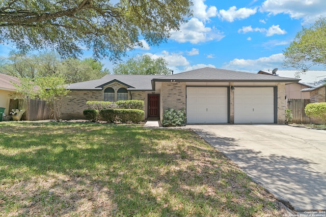 ranch-style home featuring a garage and a front lawn