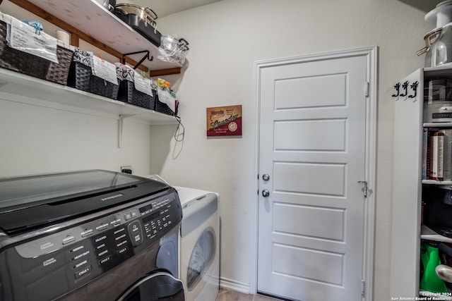 clothes washing area with washer and clothes dryer