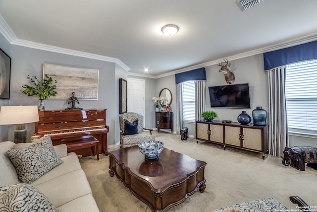 living room with a healthy amount of sunlight, ornamental molding, and light colored carpet