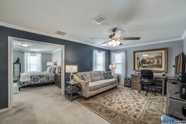 bedroom with a textured ceiling, crown molding, light carpet, and ceiling fan