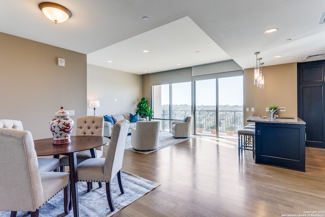 dining space featuring light hardwood / wood-style flooring and sink