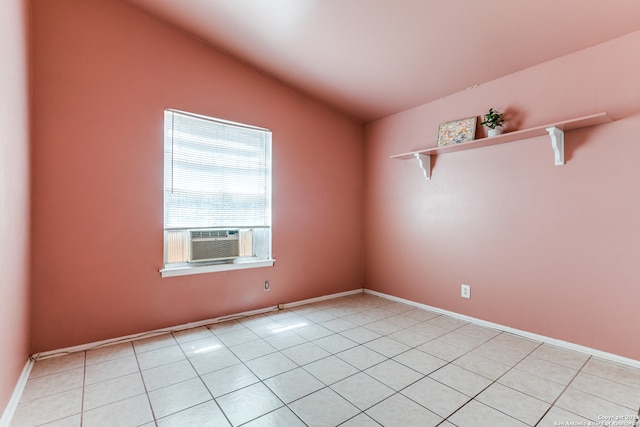 tiled empty room with cooling unit and vaulted ceiling