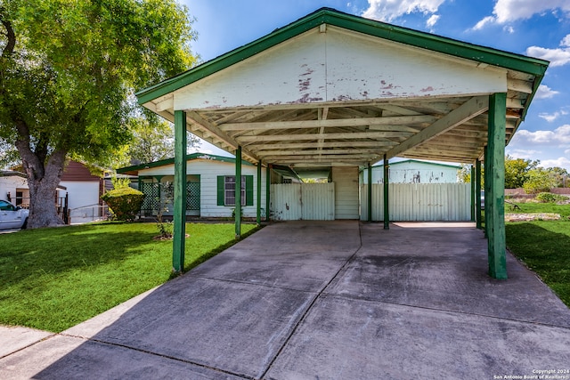 view of parking featuring a yard and a carport