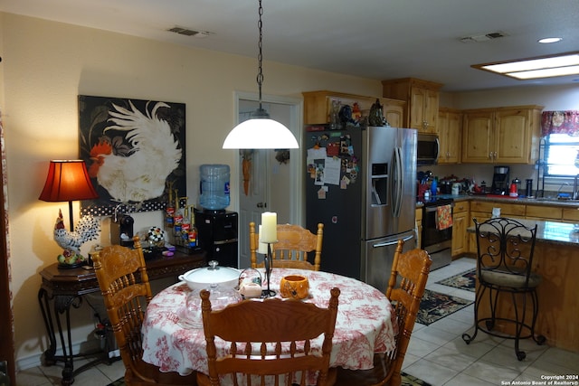 tiled dining space featuring sink