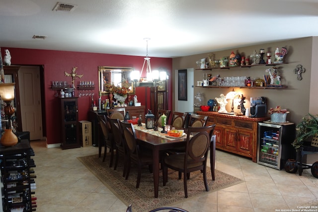 dining area featuring a chandelier and light tile patterned flooring