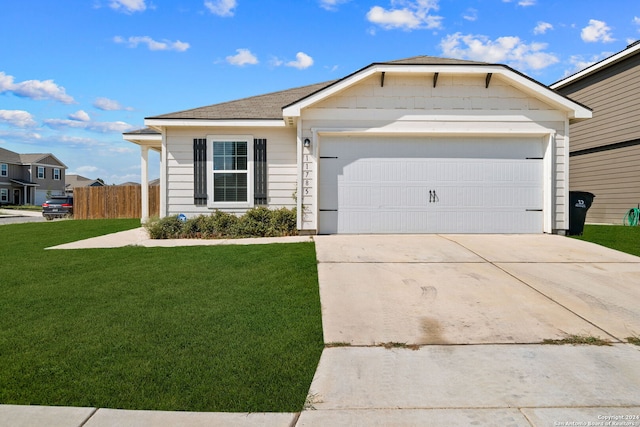 ranch-style house featuring a front yard and a garage