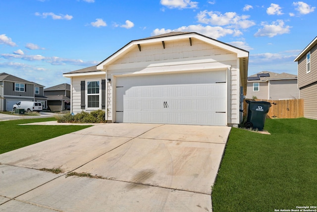 ranch-style home featuring a front yard and a garage