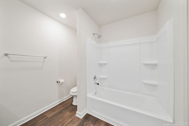 bathroom featuring tub / shower combination, toilet, and hardwood / wood-style flooring