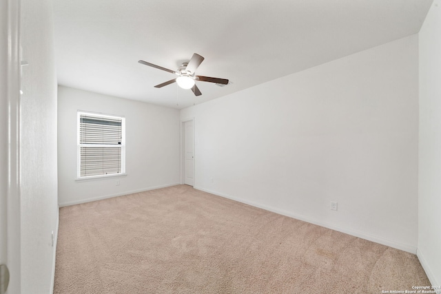 unfurnished room with ceiling fan and light colored carpet