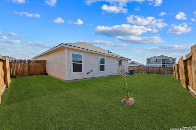 rear view of house with a yard