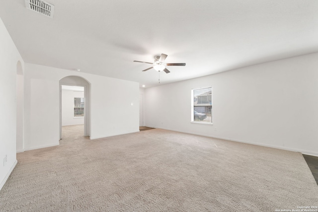 carpeted empty room featuring ceiling fan