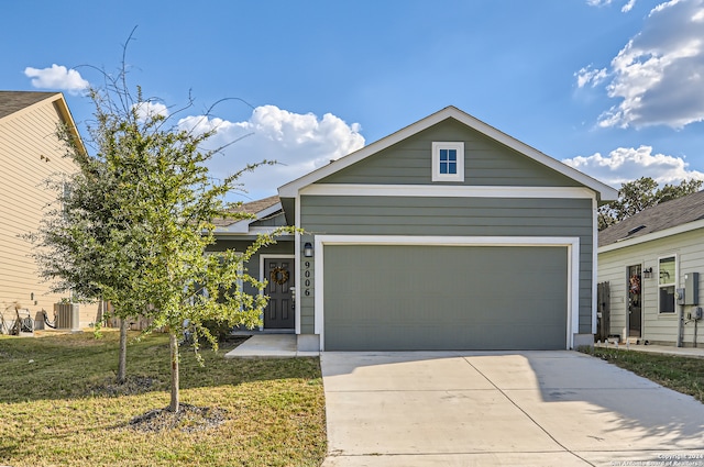 view of front facade with a garage, central air condition unit, and a front yard