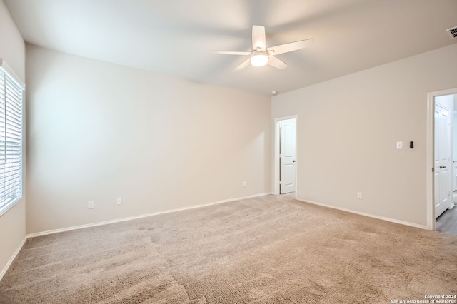 empty room with ceiling fan and carpet floors