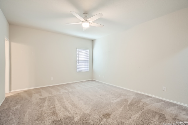 empty room with ceiling fan and light colored carpet