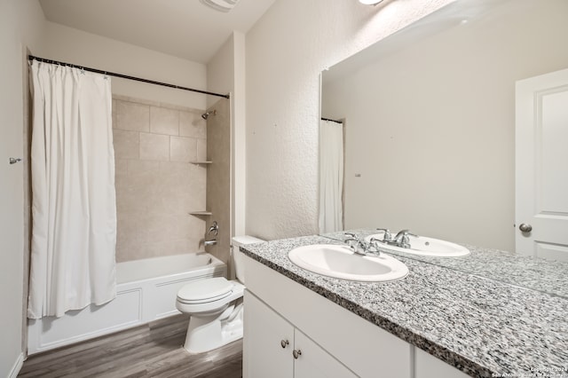 full bathroom featuring wood-type flooring, vanity, toilet, and shower / bath combo with shower curtain