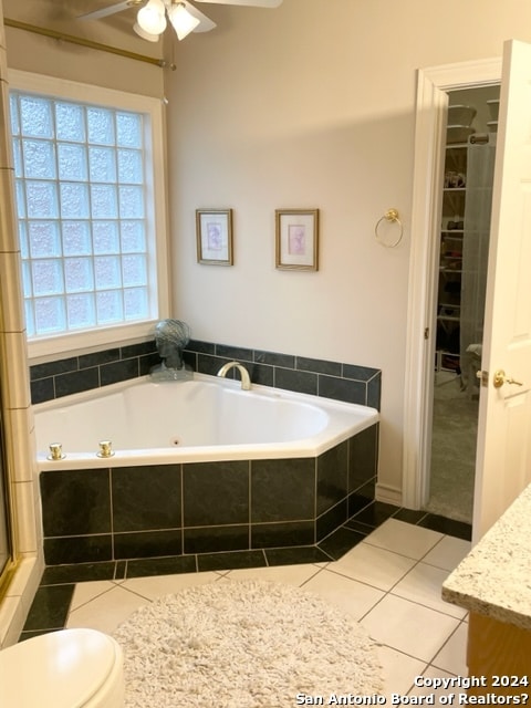 full bathroom featuring plus walk in shower, tile patterned flooring, vanity, and toilet