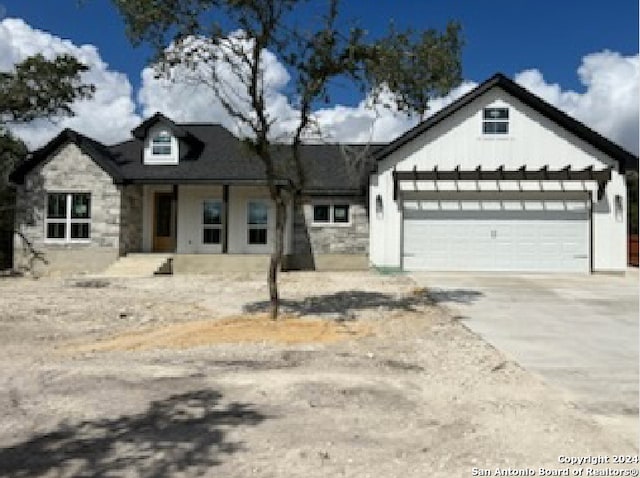 view of front of house featuring covered porch and a garage