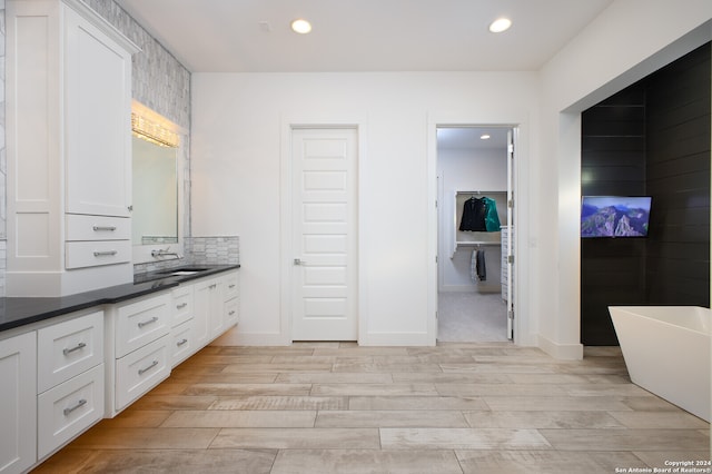 bathroom featuring a bathtub, vanity, and hardwood / wood-style flooring