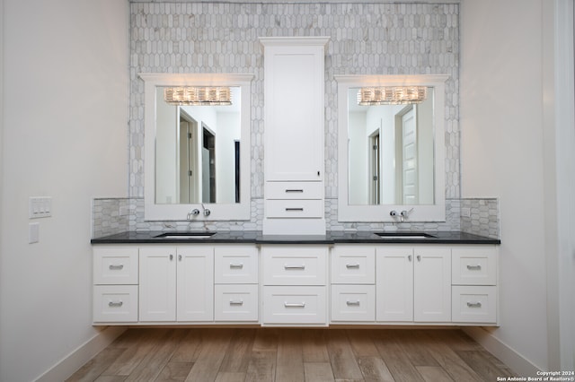 bathroom with vanity, hardwood / wood-style floors, and decorative backsplash