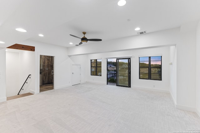 empty room with ceiling fan and light colored carpet