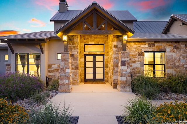 view of exterior entry at dusk