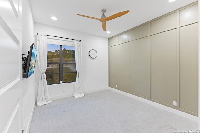 empty room with light carpet and ceiling fan