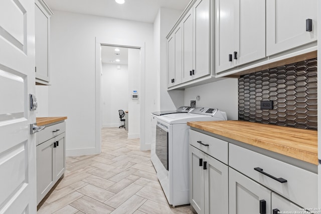 laundry area with cabinets and independent washer and dryer