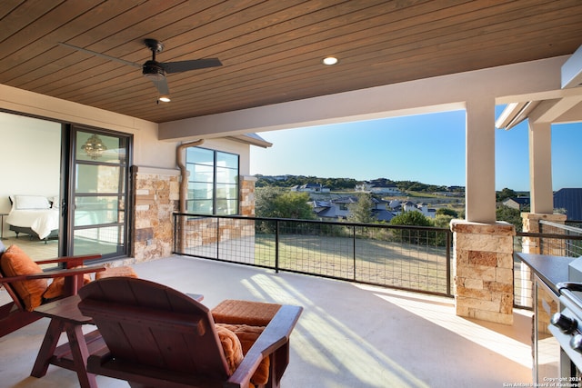 view of patio featuring a balcony and ceiling fan