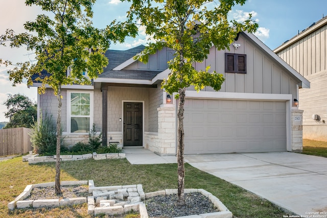 view of front of home featuring a garage and a front lawn