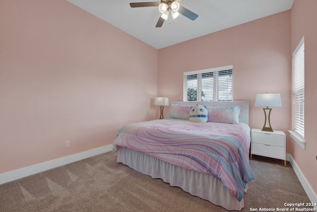 bedroom featuring ceiling fan, carpet, and multiple windows