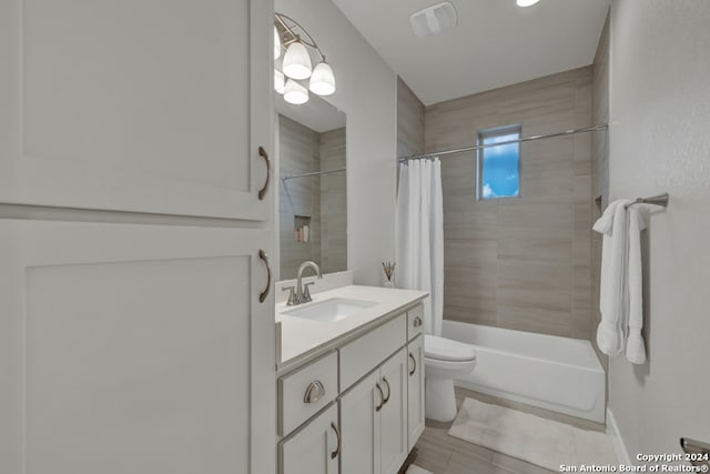 full bathroom featuring shower / bath combo with shower curtain, vanity, and toilet