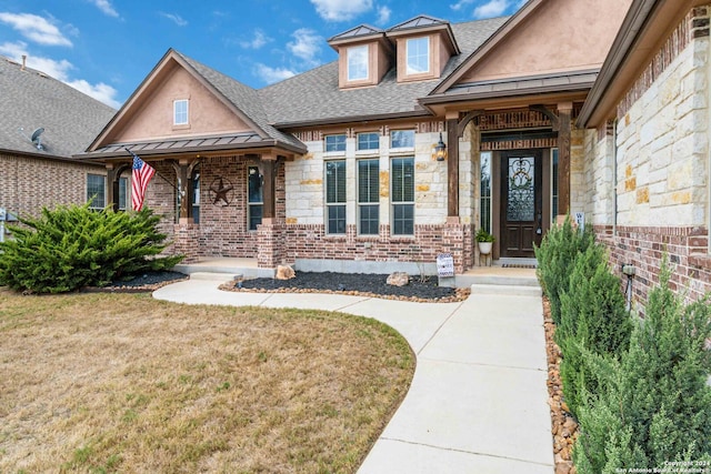 view of exterior entry featuring a yard