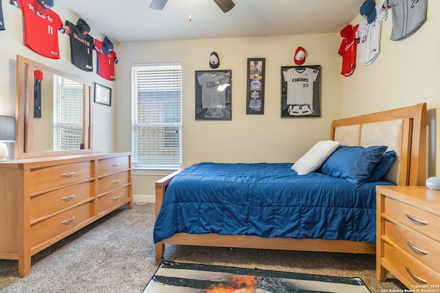 bedroom with ceiling fan and light carpet