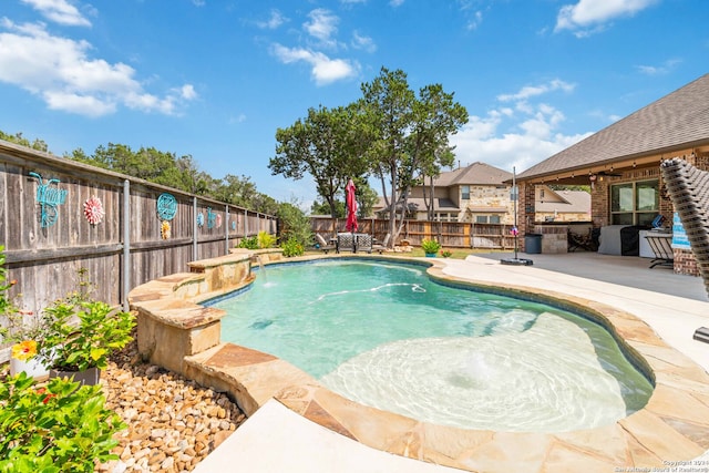 view of pool with a patio area and pool water feature