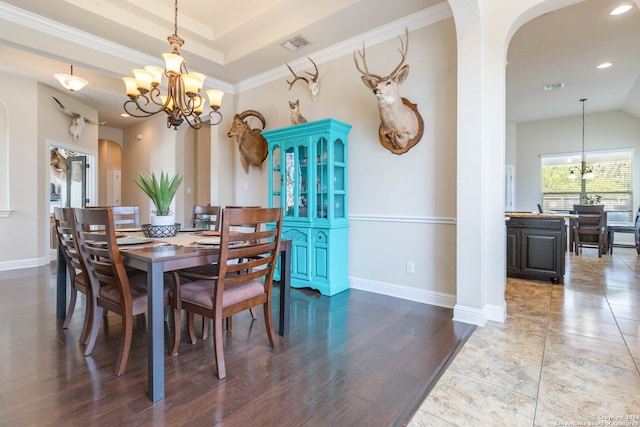 dining space featuring a notable chandelier, crown molding, and dark hardwood / wood-style flooring