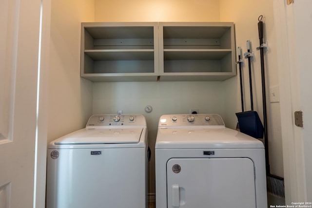 clothes washing area with washing machine and dryer