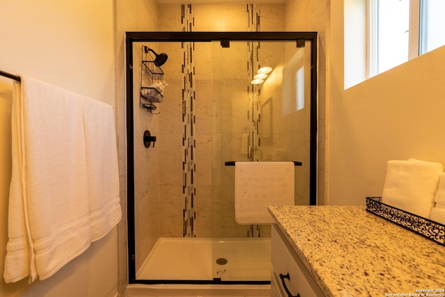 bathroom with walk in shower and vanity