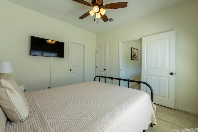 bedroom with light hardwood / wood-style floors and ceiling fan