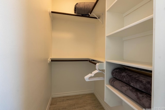 walk in closet with wood-type flooring