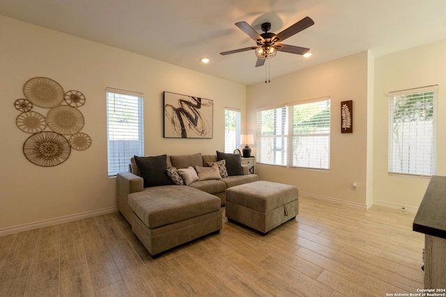 living room with ceiling fan, light hardwood / wood-style floors, and a wealth of natural light