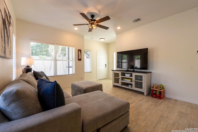 living room with light hardwood / wood-style floors and ceiling fan